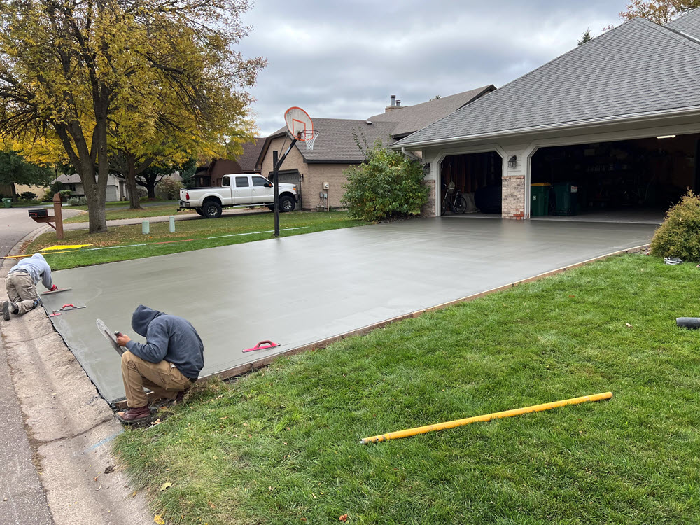 Freshly poured concrete driveway installed in Brooklyn Park MN by Creative Concrete Inc